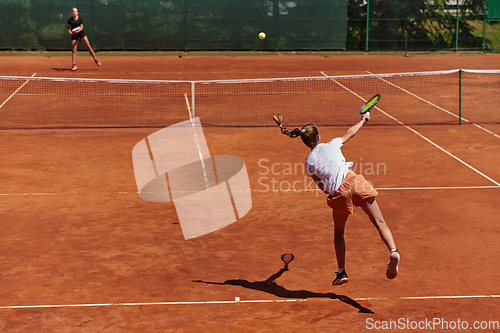 Image of Young girls in a lively tennis match on a sunny day, demonstrating their skills and enthusiasm on a modern tennis court.