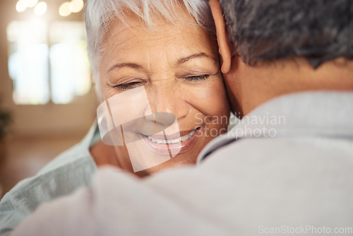 Image of Love, smile and elderly couple hug in their home, happy and relax while bonding and embracing. Care, affection and calm mature man and woman enjoying romance, intimacy and retirement in their home