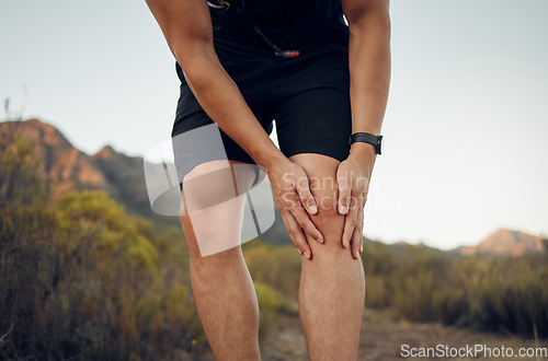 Image of Man, knee pain and injury in fitness exercise, training and health workout in nature park or countryside hiking trail. Zoom, hands and sports runner with risk emergency and medical leg accident