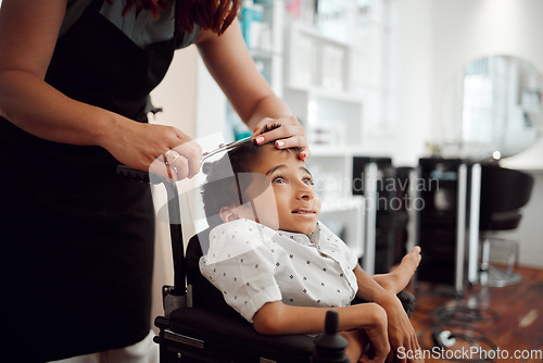 Image of Hair, cut and young disability child at a grooming, hairdressing or barber salon for hair care service appointment. Help, support and hands of hairdresser cutting physical disabled kid in wheelchair