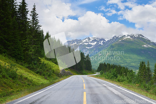 Image of Road mountain, highway and countryside environment with freedom for travel, summer snow in Alaska and street or adventure. Landscape of calm driveway path in nature for transportation on holiday