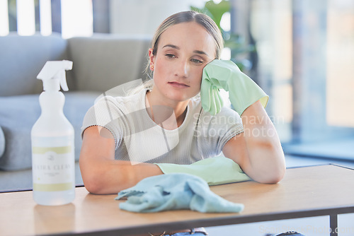 Image of Woman, tired and burnout after cleaning house, office or home with spray, chemical or sanitizer. Cleaner, gloves and table for domestic work, job or service take time to rest, breathe and relax