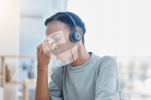 Image of Stress, burnout and sad call center worker with a headache and office anxiety sitting in an office. Frustrated, sick or depression black woman customer service employee with pain or mental health