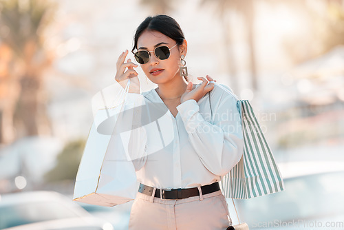 Image of Shopping, fashion and city woman with bag walk on street road after buying luxury designer clothes on sales discount. Rich, wealth or chic customer travel in Toronto Canada after retail therapy spree