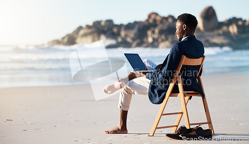 Image of Beach, work and black man reading an email on a laptop with 5g internet while working by ocean. Relax, smile and happy African businessman doing remote business on a chair at the beach with computer