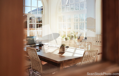 Image of Interior, room and design with an empty home office in an office of a modern workplace during the day. Building, architecture and table in a corporate company for meeting or strategy after hours