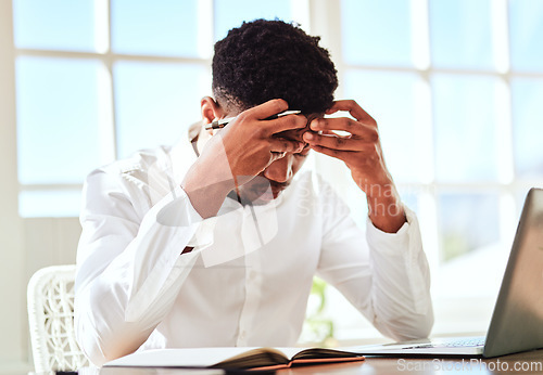 Image of Headache, stress and businessman with burnout from work problem in office. Sad and tired corporate African employee with anxiety and depression while working on a project on internet with a laptop