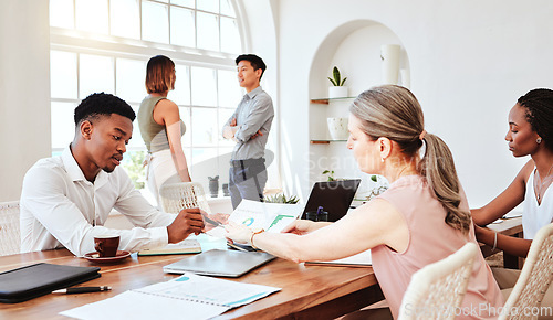 Image of Business people, analytics and meeting for team collaboration or discussion of company data at the office. Group of analysts in teamwork planning, strategy and marketing conversation at a conference