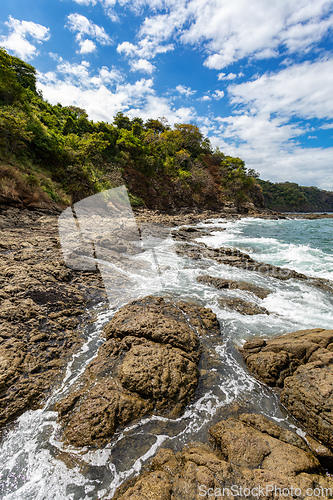 Image of Playa Ocotal and Pacific ocean waves on rocky shore, El Coco Costa Rica