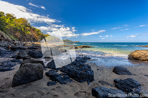 Image of Playa Ocotal and Pacific ocean waves on rocky shore, El Coco Costa Rica