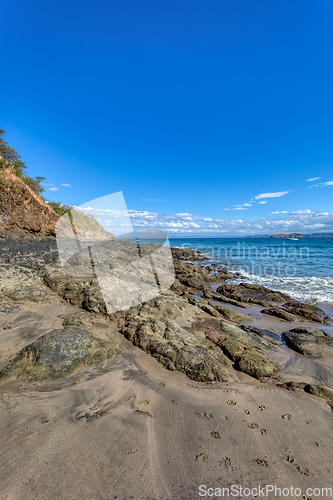 Image of Playa Ocotal and Pacific ocean waves on rocky shore, El Coco Costa Rica