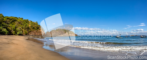 Image of Playa Ocotal and Pacific ocean waves on rocky shore, El Coco Costa Rica