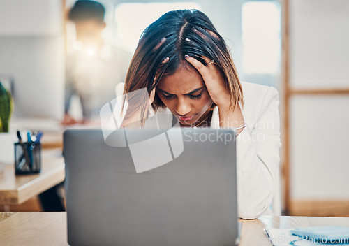 Image of Headache, stress and business woman with burnout from work problem on a laptop in an office. Sad, tired and Indian corporate worker with anxiety while working on internet on a computer at her desk