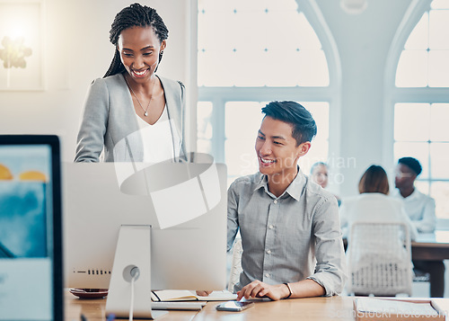 Image of Employees, coworkers and training with computer doing research, speaking about project outcome and analysis at office desk. Smile, Asian man and black woman planning an online company strategy