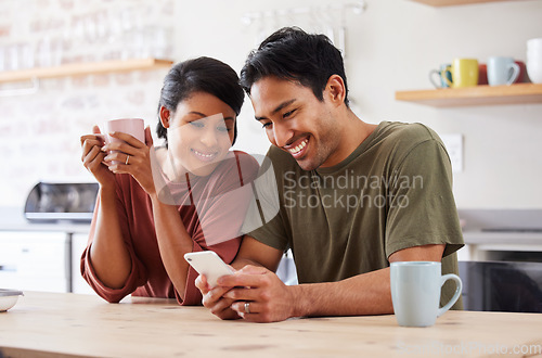 Image of Phone, social media and couple with a man and woman in the kitchen of their home together in the morning. Mobile, coffee and communicaton with a married male and female reading a text in their house