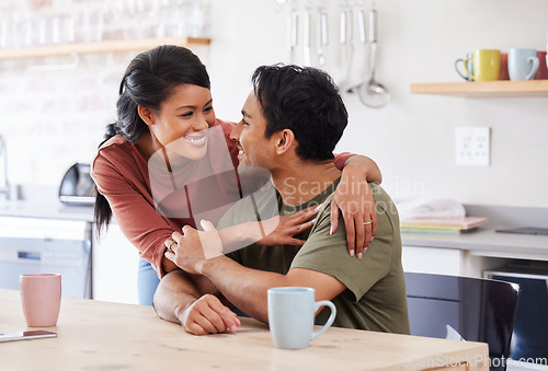 Image of Couple love, happy and support or care conversation, hug and talking together at kitchen table. Married Asian man and woman affection or loving, healthy bonding and romantic smile at family house