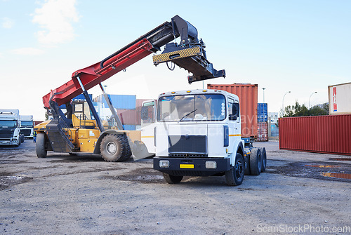 Image of Truck, logistics and supply chain with a construction driver on a commercial container yard for shipping or distribution. Storage, stock and cargo with a vehicle in the import and export industry
