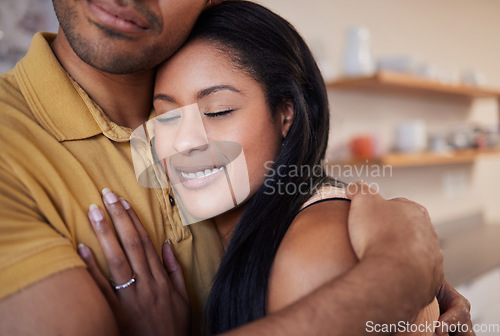 Image of Hug, love and African couple with smile for marriage or anniversary in their house together. Young man and woman hugging with affection and happy on a date in the kitchen of their apartment home