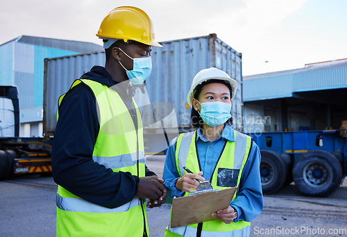 Image of Covid, logistics and checklist employees and mask at shipyard, clipboard and discuss cargo transportation. Employees, black male and asian female talk shipping supply chain storage, import and export