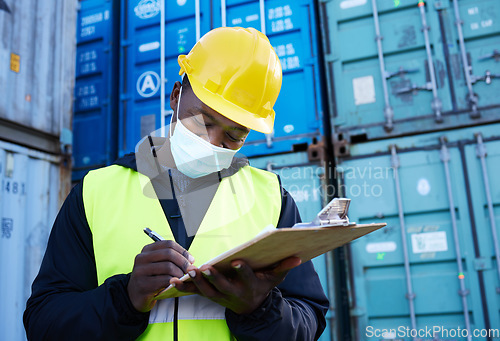 Image of Logistics worker, container port and covid, black man writing on inventory checklist. Cargo yard, export and safety for shipping port employee or inspector with clipboard at global freight company.