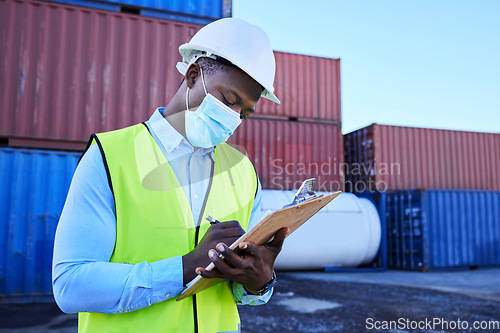 Image of Black man working in covid with face mask, shipping container in supply chain industry and logistics stock inventory. Healthcare safety in export company, essential worker in port and medical virus