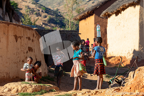Image of Morning ritual in Lakanga village as Malagasy girls fetch water for cooking. Andringitra mountain, Madagascar