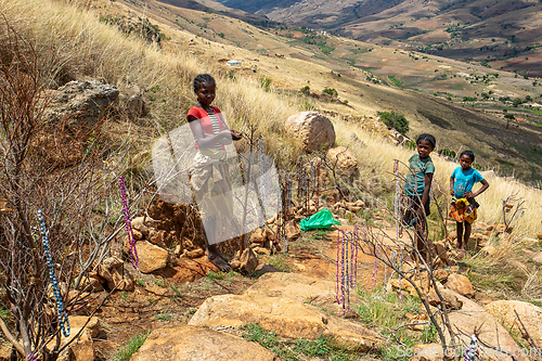 Image of Local young girl and boy selling souvenirs standing in mountainous landscape. Andringitra, Madagascar