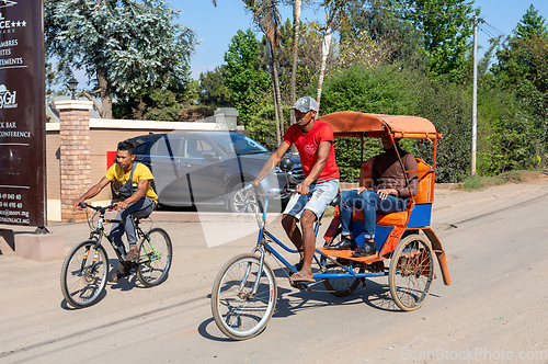 Image of Traditional rickshaw on the Antsirabe city streets. Rickshaws are a common mode of transport in Madagascar.