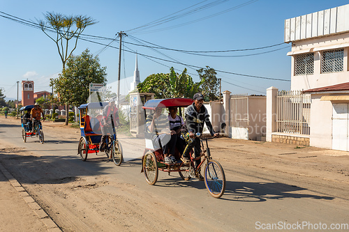 Image of Traditional rickshaw on the Antsirabe city streets. Rickshaws are a common mode of transport in Madagascar.