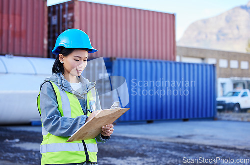 Image of Logistics, inspection and worker working on shipping of delivery at an outdoor warehouse or port. Asian industrial employee writing notes and inventory while working in the supply chain business
