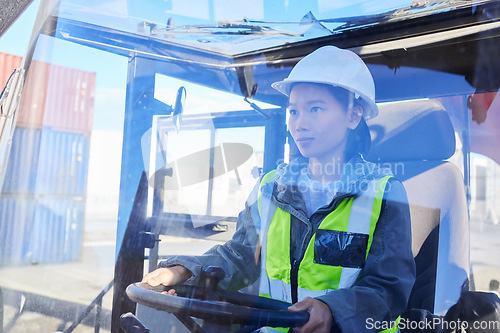 Image of Asian woman, logistics and machine for industry shipping at work for transportation in container yard. An engineer working in industrial warehouse with transport machinery for cargo shipment