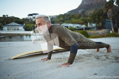 Image of Senior man, beach and fitness in South Africa of surfer in exercise for morning routine warm up. Elderly male in surfing sports and training pushups getting ready for healthy workout by the ocean