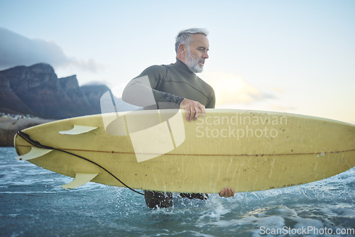 Image of Surf, board and senior man in ocean for fun, adventure or sports exercise while surfing in Rio de Janeiro Brazil. Surfer lifestyle, freedom and elderly person in the sea for wellness, health or peace