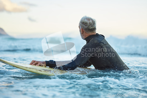 Image of Water, board and surfer surfing the waves at the beach on holiday in Thailand during sunrise in summer. Man in the ocean with a surfboard on a travel vacation for nature adventure by the sea