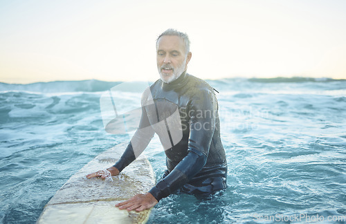 Image of Surfing, ocean and senior man swimming with board in sea blue waves and morning sky mockup. Sports, fitness and adventure surfer in tropical water for vacation, summer holiday or wellness lifestyle