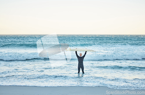 Image of Senior man, surfboard and ocean surfer, ready to surf Canada sea waves on summer holiday or vacation. Fitness, workout and elderly male in retirement surfing, recreation exercise or water sports.