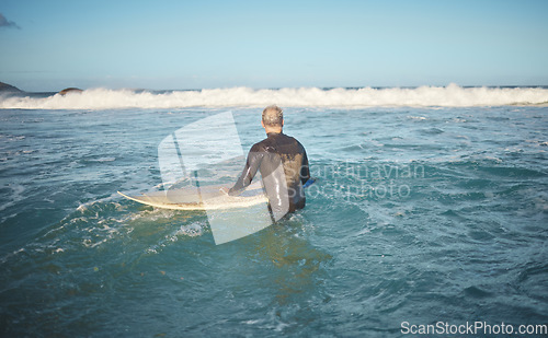 Image of Surfer and man in water watching wave for high tide while holding surfboard at sunny USA beach. Retirement person enjoying surfing sport leisure in California waiting for ocean level to rise.