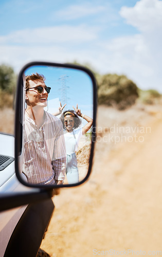 Image of Couple on road trip, smile in car mirror reflection and happy smile with love on desert holiday road trip drive in South Africa. Summer vacation in the wild, diverse male and female friends with fun