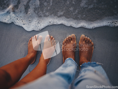 Image of Couple feet, beach sand and water at ocean waves, nature and summer travel for vacation, honeymoon date and tropical holiday outdoors. Closeup above man, woman and foot toes at sea, relax and freedom