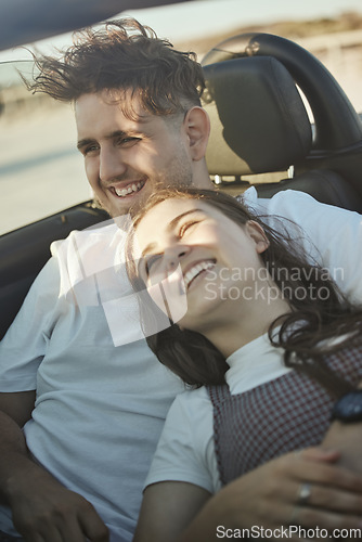 Image of Roadtrip, travel and couple in a car on the road together, taking a drive. Love, dating and happy couple in motor vehicle hugging, laughing and smile on their face on holiday, vacation and adventure