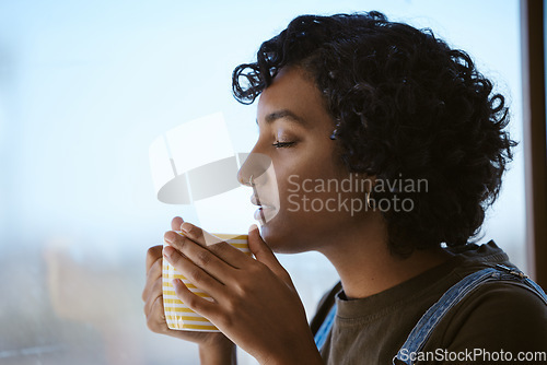 Image of Indian woman drinking coffee, tea and happy peace, mindset and relaxing at home window. Face of hipster young gen z girl sipping hot beverage mug for calm day, lifestyle and break alone in apartment