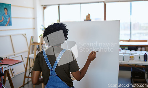 Image of Art, paint and creative woman painting on canvas with inspiration in a workshop studio from behind. Back of an artist, designer or painter learning about creativity in class at an academy with vision