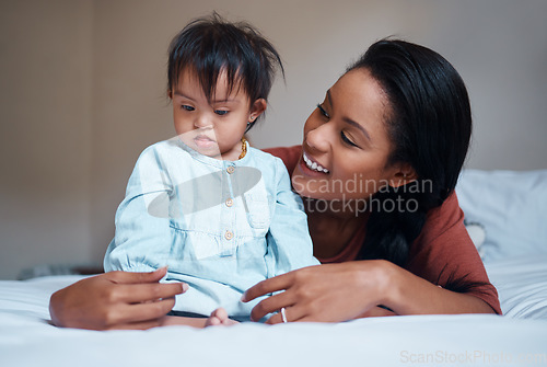 Image of Love, mother and down syndrome baby in bedroom together to relax and bond in Puerto Rico house. Care, love and support of mom embracing child with mental disability on bed in happy family home.