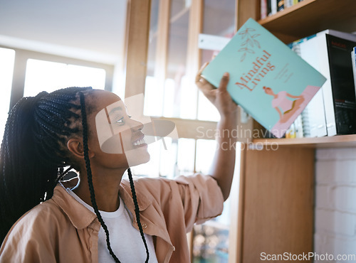 Image of Black woman, happy and home library books ready to spend a calm, relax and content reading day. Happy smile of a person from Jamaica holding a mindfulness living book in a house for mental health