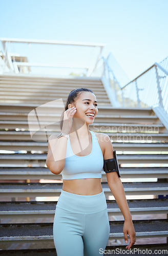 Image of Fitness, exercise and music with a woman runner or athlete streaming radio outside for workout, training and health. Sports, healthy and cardio with a female listening on earphones while out on a run