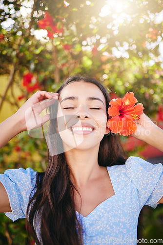 Image of Girl, tropical flower and garden in summer sunshine on vacation, holiday and spring break in Hawaii. Happiness, wellness and beauty skin care or zen mental health self love, peace, happy and smile.