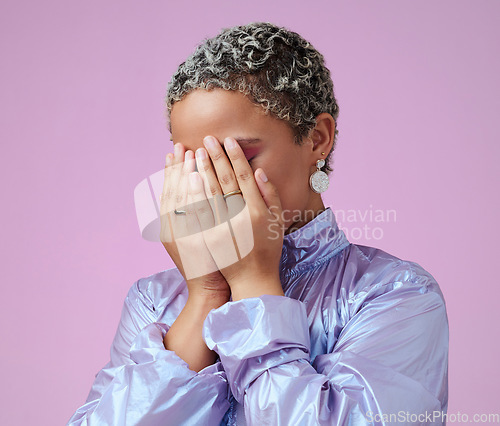 Image of Hands, shy and hiding black woman in studio, embarrassed by trendy fashion and edgy makeup. Beauty, hand and face covering by cute lady hide after glamour and makeover against pink background mockup