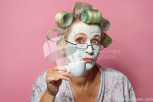 Image of funny senior woman with cosmetic face mask