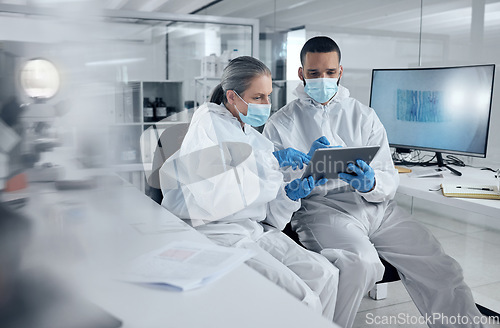 Image of Research, covid and tablet with doctors reading information for work discussion. Medical, team and PPE for safety, health and wellness while doing research on coronavirus together in lab at hospital