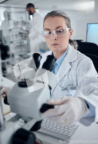 Image of Science microscope, woman professor and laboratory research, medical innovation or biology test. Senior analytics scientist, chemistry expert and physics worker check focus on dna healthcare analysis